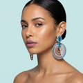 Model wearing rose gold light blue CZ luxury dangle drop earrings
