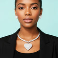 Model wearing cubic zirconia heart pendant necklace and earrings