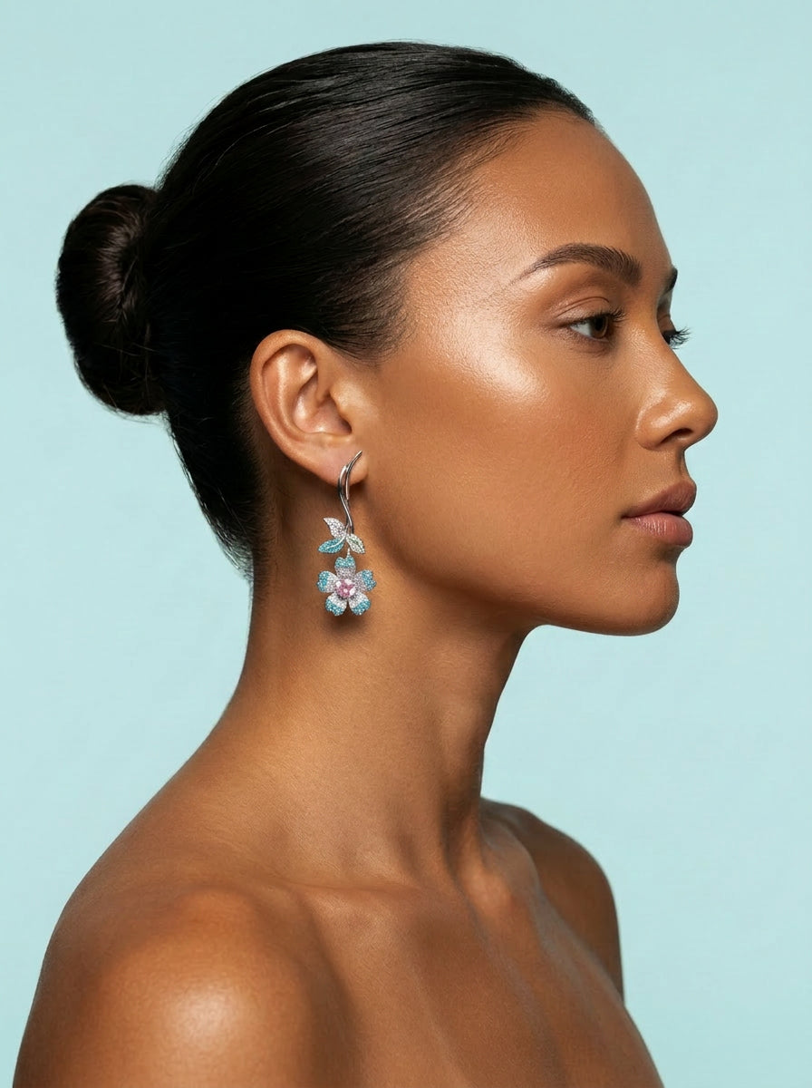 Toned model wearing turquoise flower pink heart CZ earring