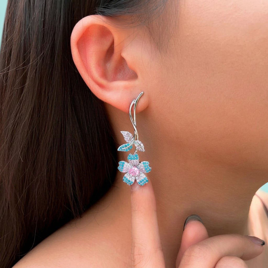 Model wearing turquoise flower pink heart CZ earring