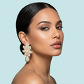Model wearing luxury gold leaf drop earrings