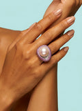 Toned model wearing pink pearl statement ring