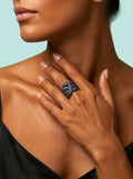 Toned model wearing rainbow twist ring