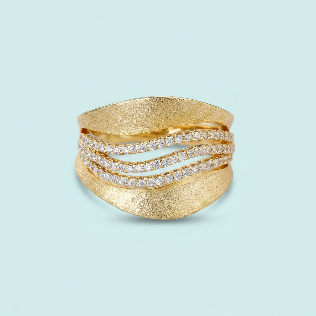 Gold cubic zirconia wave ring on aqua background